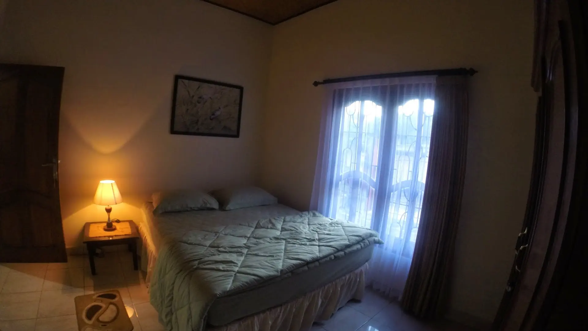 Guest bedroom with a bed and bedside lamps in warm light